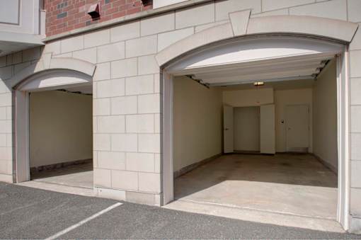 A white building with two open garage doors.