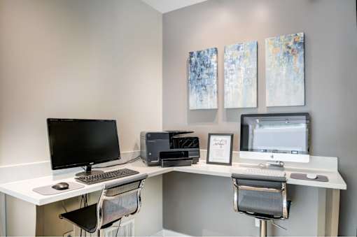 A white desk with a computer monitor, keyboard, and mouse.