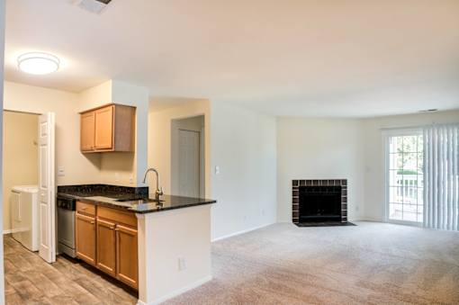 A kitchen with a black countertop and wooden cabinets.