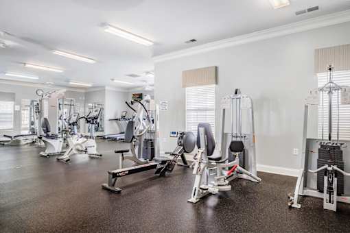 A gym with a variety of exercise equipment.