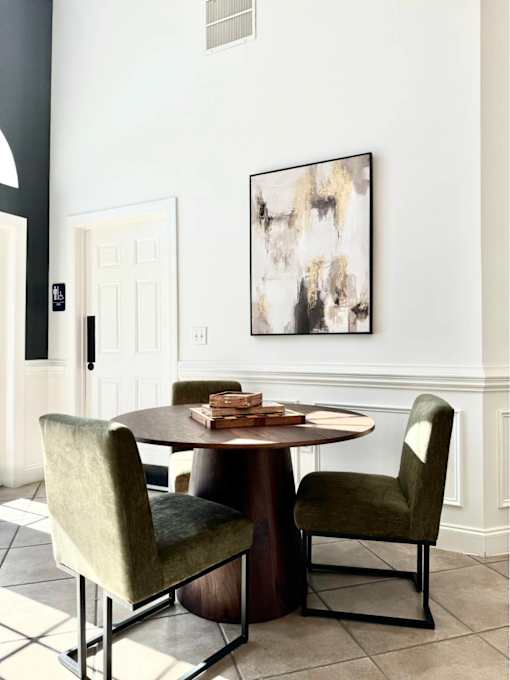 A dining room with a table and chairs.
