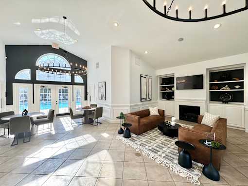 A living room with a fireplace and a large window.