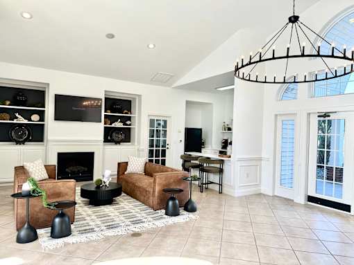 A living room with a fireplace and a chandelier.