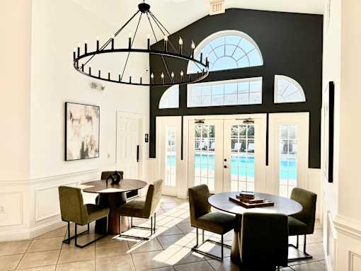 A dining room with a table set for four.