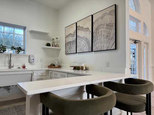 A modern kitchen with a large table and chairs.