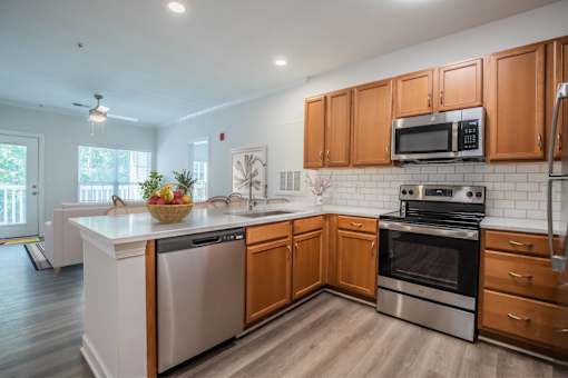 A kitchen with wooden cabinets and stainless steel appliances.
