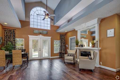 A living room with a fireplace and a dining table.