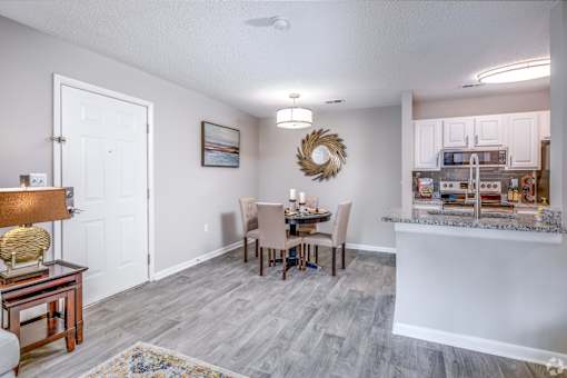 A dining room with a table set for four.