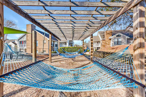 A blue rope bridge in a residential area.