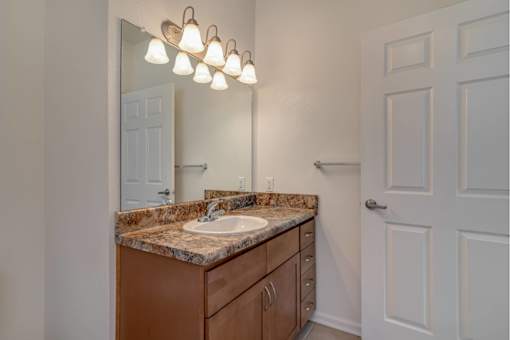 Bathroom counter with single sink and shaker style cabinets
