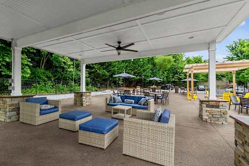 A patio with a white roof and a ceiling fan.