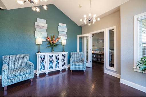 A room with blue walls and a wooden floor.