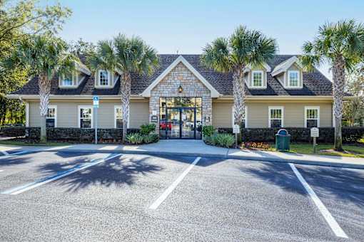 A building with a parking lot in front of it.