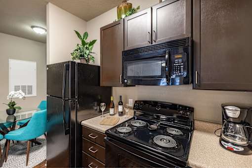 Big oaks apartments lakeland florida model kitchen with black appliances and wooden cabinets