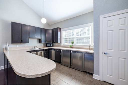 A kitchen with a countertop and stainless steel appliances.