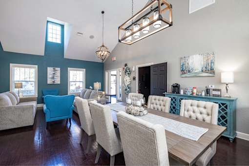 A dining room with a long table and chairs.