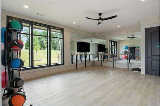 Large Yoga Studio with Mirrors, Wood Flooring, and Ample Natural Light.