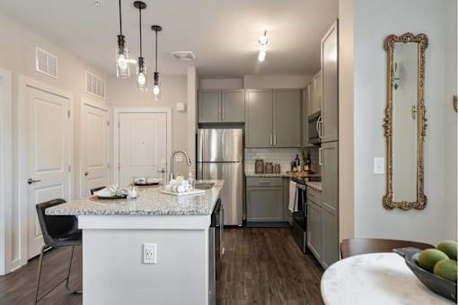 Two Bedroom Apartments in Nashville, TN - The Sound at Pennington Bend - An Interior Shot of The Large Kitchen with Stainless Steel Appliances, Granite Countertops, and Wood Flooring
