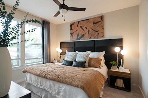 Nashville TN Apartments - The Sound at Pennington Bend - An interior shot of the spacious bedroom featuring two windows and plush carpeting