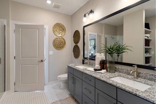 The Sound at Pennington Bend - Modern Bathroom with a Wide Mirror, Two Sinks, and Spacious Cabinets