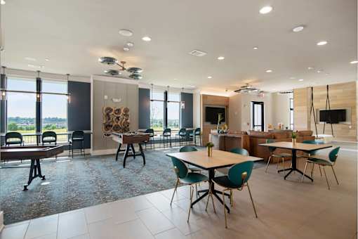 A spacious room with a dining table and chairs.