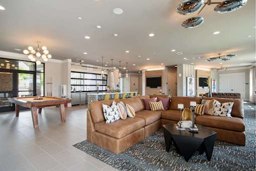 A living room with a brown couch and a coffee table.
