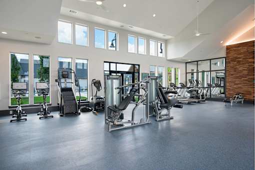 Nashville, TN, Apartments for Rent - The Sound at Pennington Bend - Fitness Center with Cardio Equipment, Strength Training Equipment, High Ceiling with Fans, Large Mirrors, and Large Windows