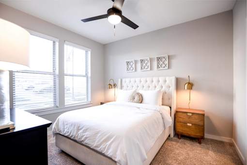 Pet Friendly Apartments in Nashville TN - The Sound at Pennington Bend - A Bedroom With A Full Size Bed Next To Two Large Windows Letting Plenty Of Light Into The Carpeted Room Complete With A Ceiling
