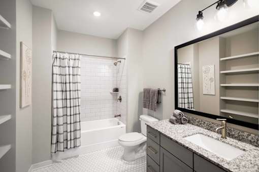 The Sound at Pennington Bend Interior-Second Bathroom with Granite Counters and Subway Tile Shower Surround