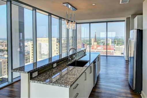 A kitchen with a view of the cityscape.