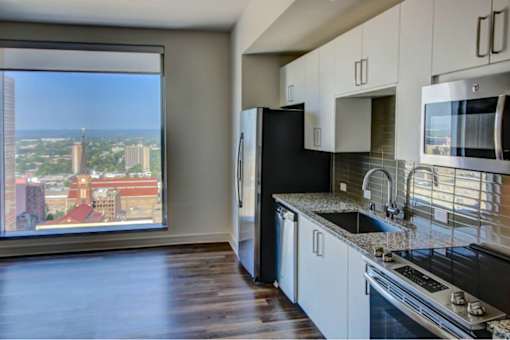A kitchen with a view of the city.