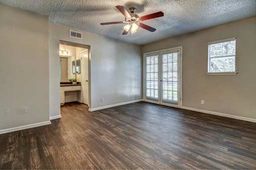 Bedroom with ceiling fan and private bathroom