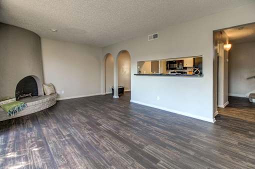 Wood-style flooring in living room, dining room, and kitchen