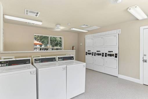 A laundry room with washers and dryers.