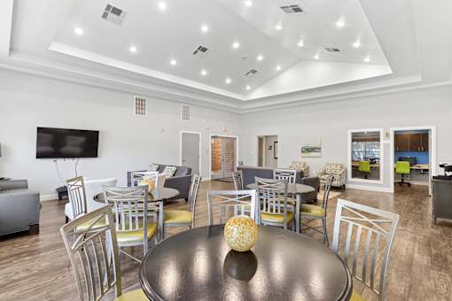 A modern dining room with a large table and chairs.