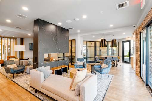A modern living room with a mix of blue and beige furniture.