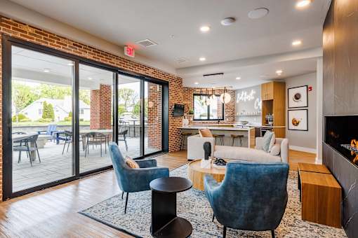 A living room with a fireplace and a dining table.