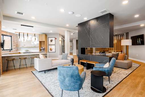 A modern living room with a bar area and a kitchen in the background.