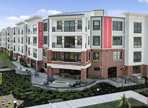 A multi-story building with a red and white sign that says "New Rentals".