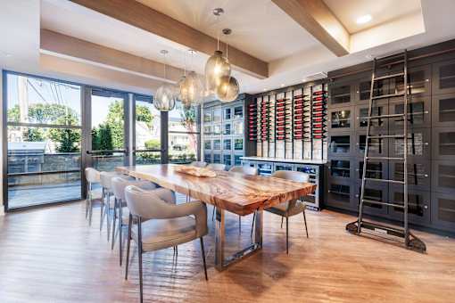 A modern dining room with a wooden table and chairs.