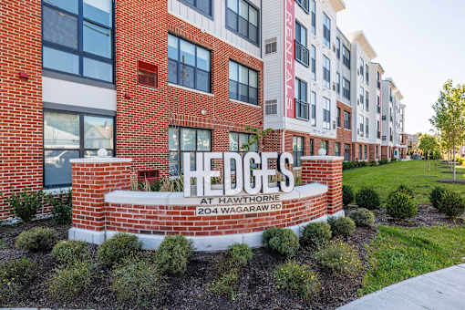 The front of a brick building with the name "Hedges" on it.