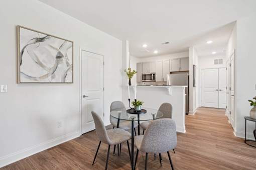A dining room with a table set for four.