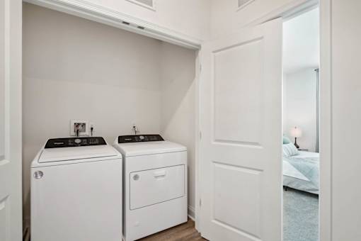 A white laundry room with a washer and dryer.