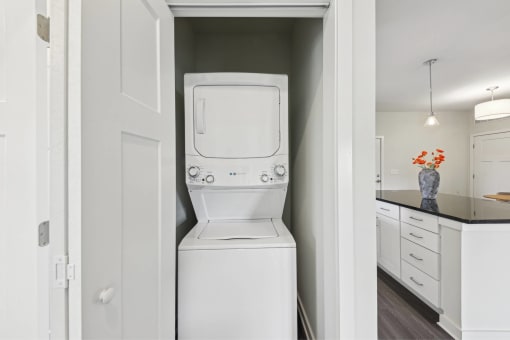 a white washer and dryer in a white laundry room