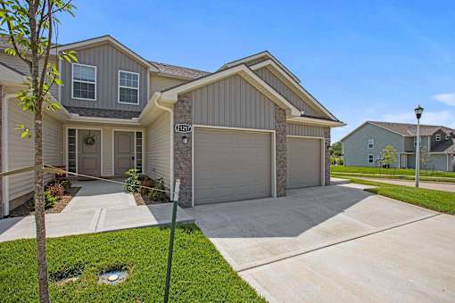 A house with a garage and a driveway in front.