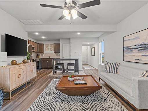 A living room with a white couch and a coffee table.