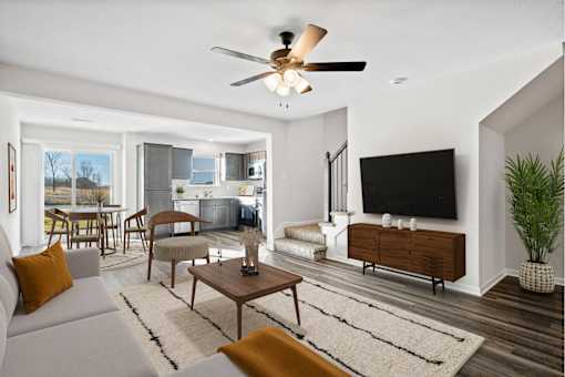 A living room with a grey couch and a wooden coffee table.