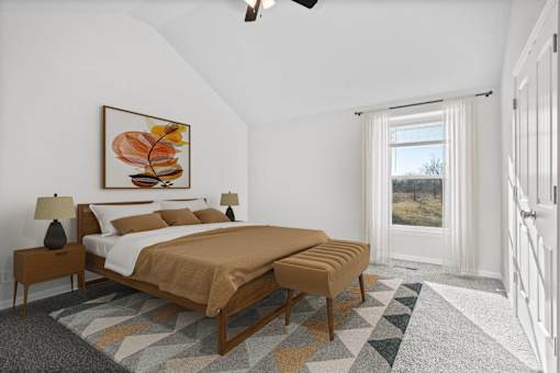 A bedroom with a large bed and a painting on the wall.