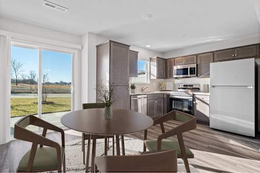 A modern kitchen with a table and chairs.