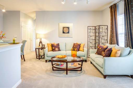 A living room with a white couch and a coffee table.
